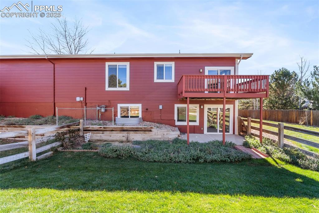 Image 41 of 50: Back of house featuring a patio area, a fenced backyard, and a deck