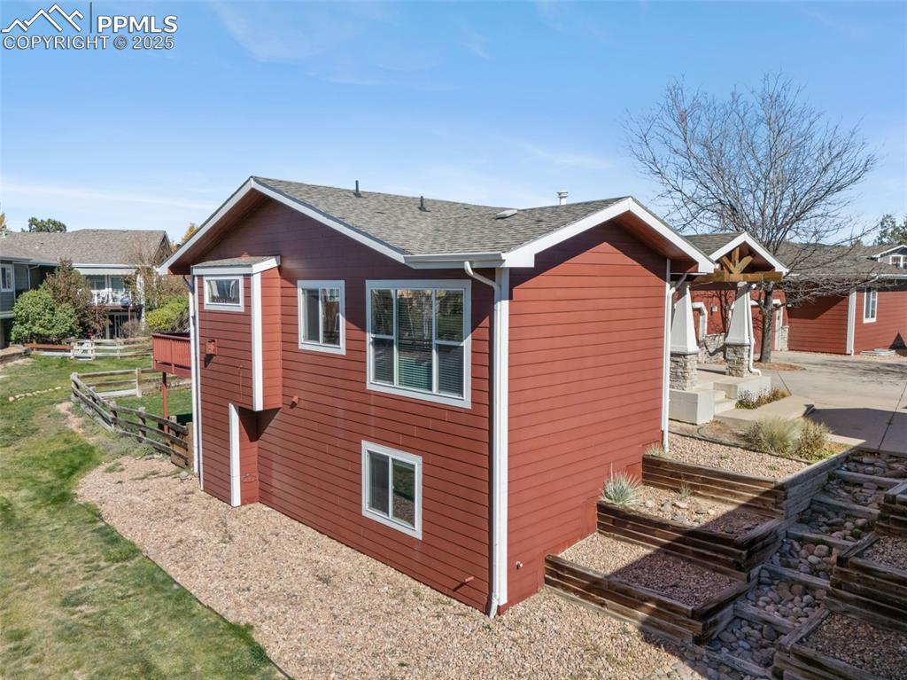 Image 47 of 50: View of side of property featuring roof with shingles