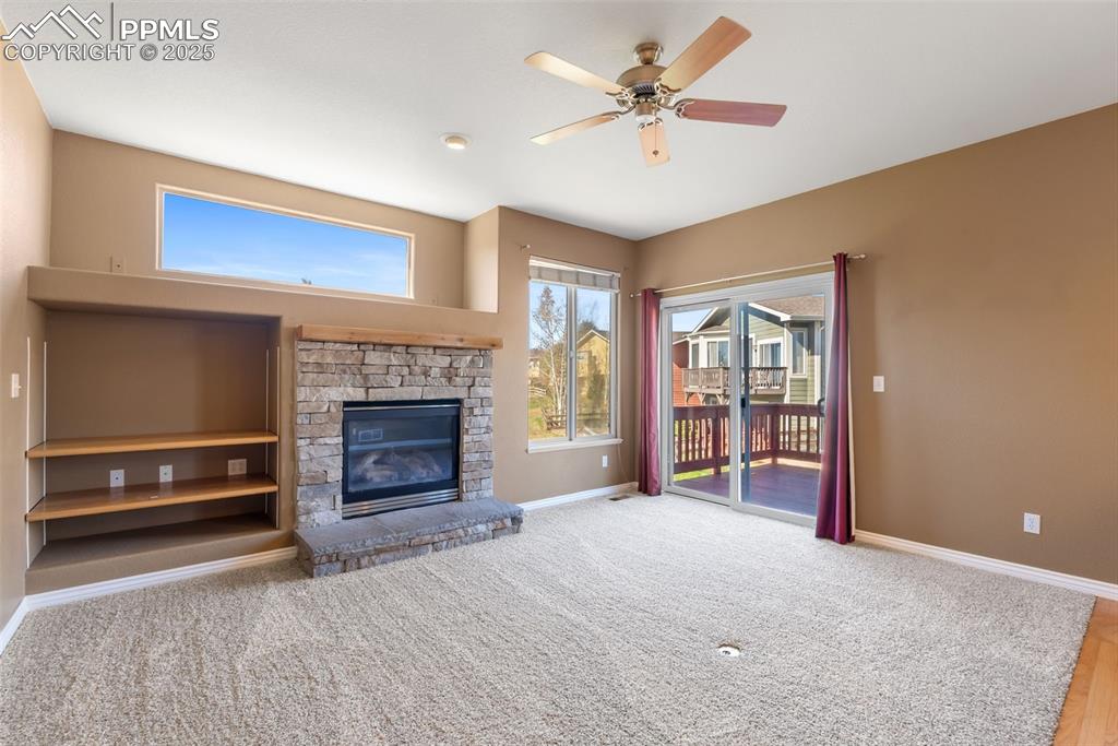 Image 9 of 50: Unfurnished living room featuring healthy amount of natural light, a firepl