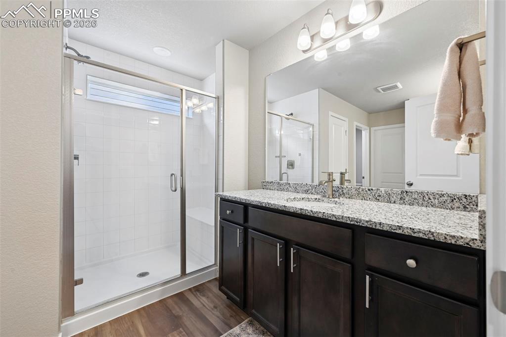 Image 31 of 42: his and hers sinks, standalone shower