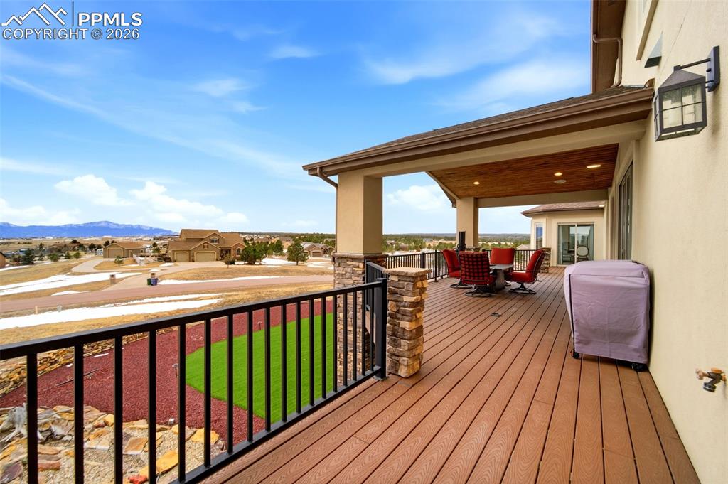 Image 17 of 48: Deck featuring a residential view, outdoor dining area, a mountain view, an