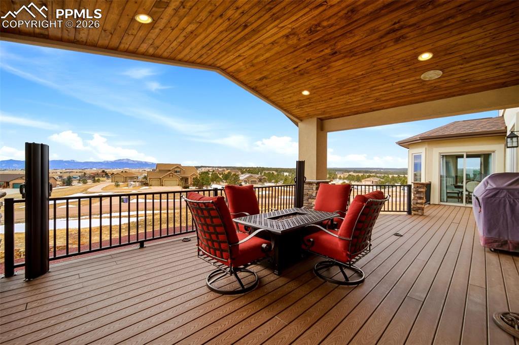 Image 18 of 48: Wooden deck featuring a residential view, a grill, outdoor dining space, an
