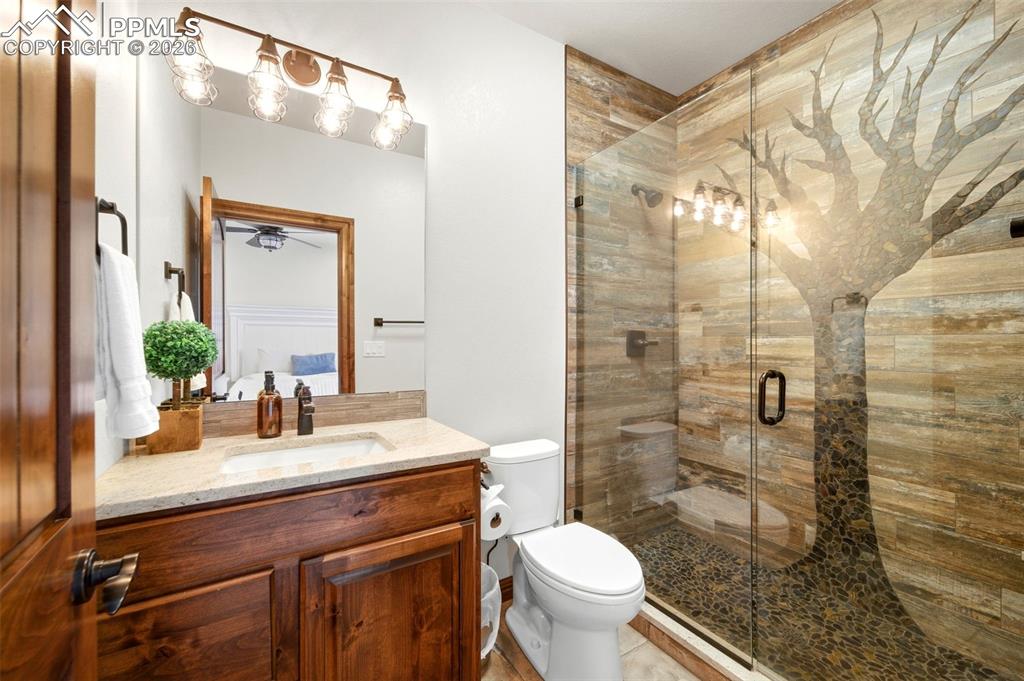 Image 26 of 48: Bathroom featuring vanity and a shower stall