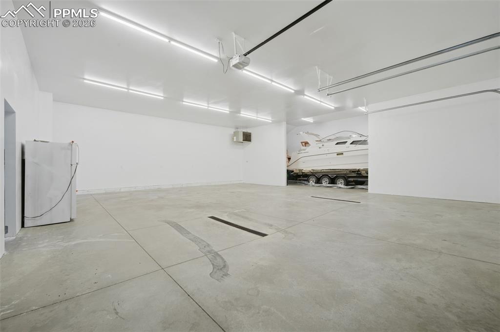 Image 42 of 48: Parking deck with freestanding refrigerator and a garage door opener