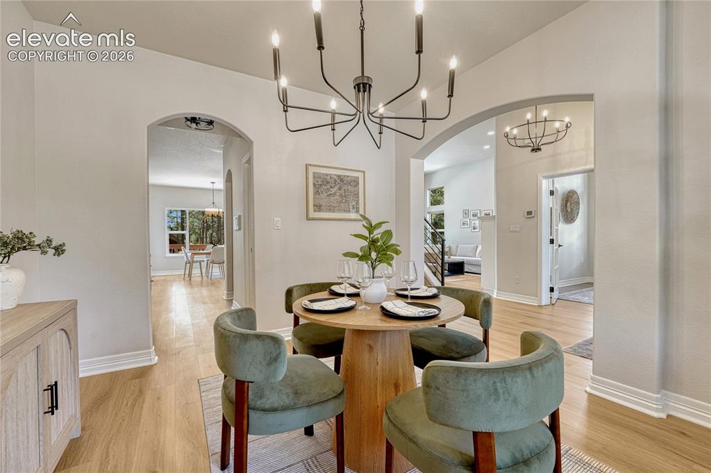 Image 10 of 49: Note the arched entries and access to both the kitchen and the great room.
