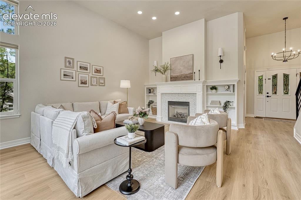Image 12 of 49: Great room with gas fireplace, 11ft ceiling...