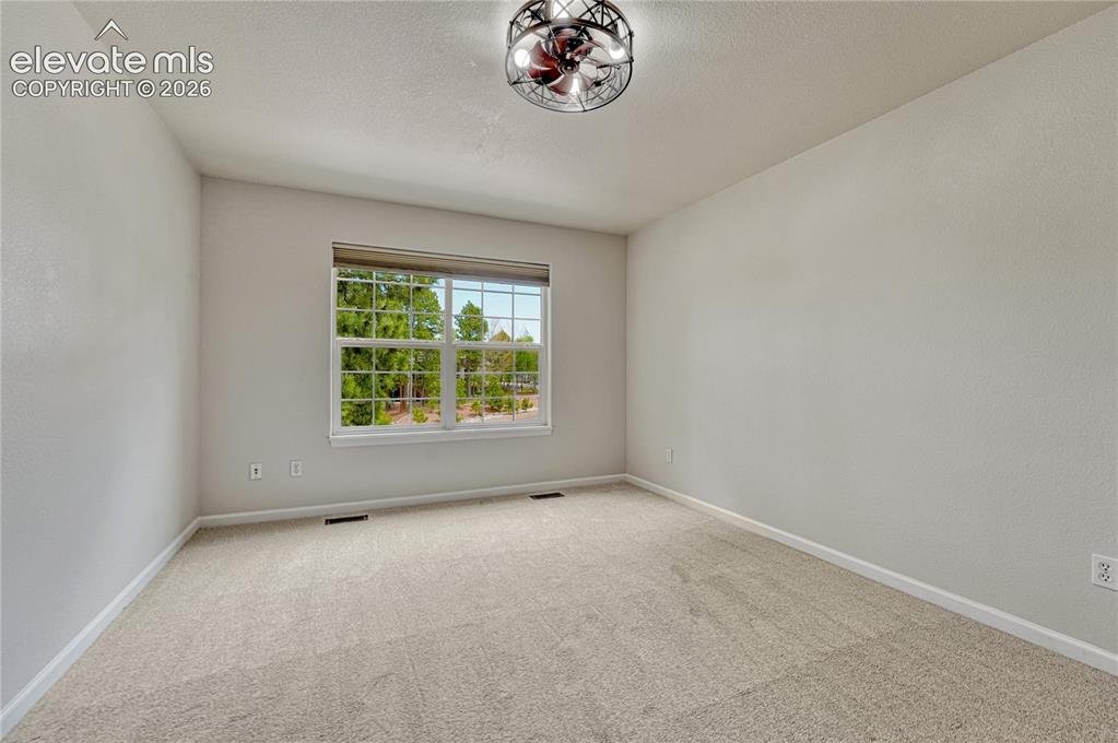 Image 35 of 49: Second of two additional upstairs bedrooms.