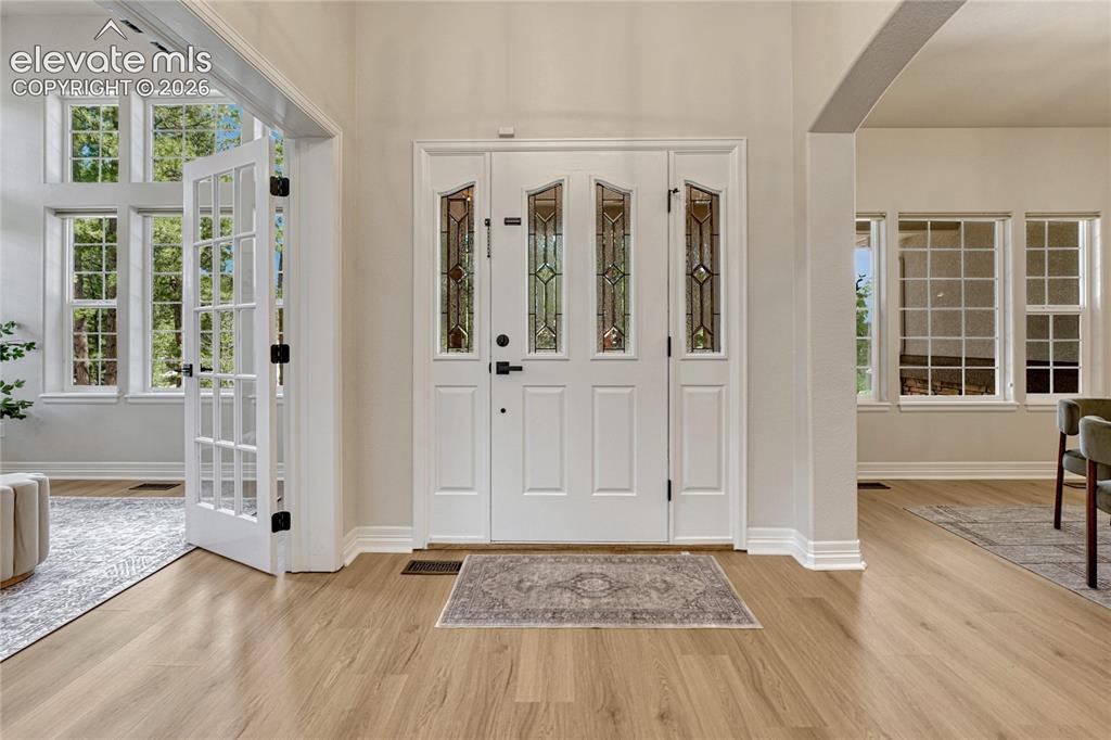 Image 5 of 49: Enter from the covered porch to this welcoming foyer.