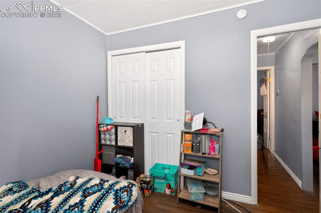 Image 10 of 20: Bedroom with ornamental molding and wood finished floors
