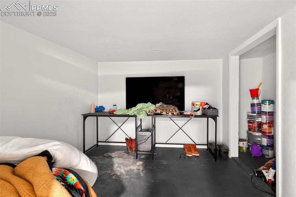 Image 12 of 20: Bedroom with finished concrete flooring