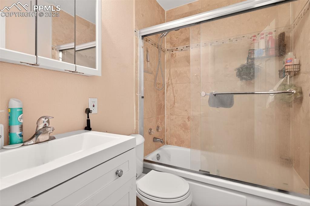 Image 13 of 20: Bathroom featuring enclosed tub / shower combo and vanity