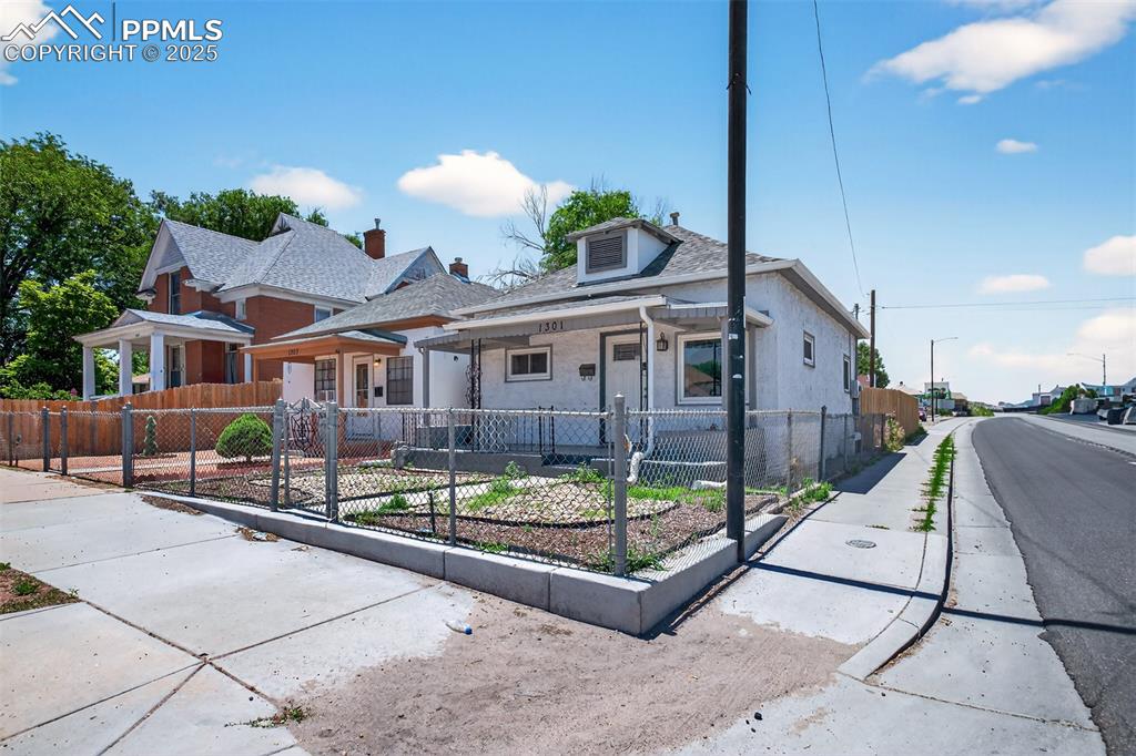 Image 18 of 20: Bungalow-style home featuring a fenced front yard