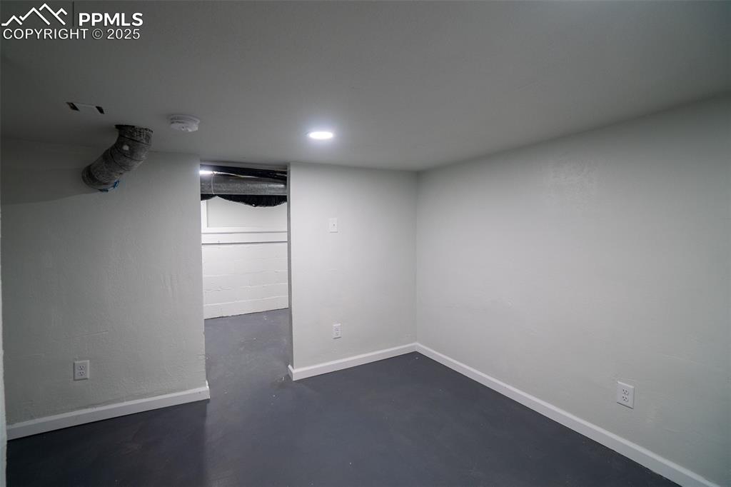 Image 22 of 29: Finished basement with baseboards and recessed lighting