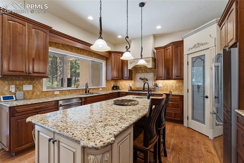 Image 16 of 46: A pantry, stone counter tops, and more views of the pines.