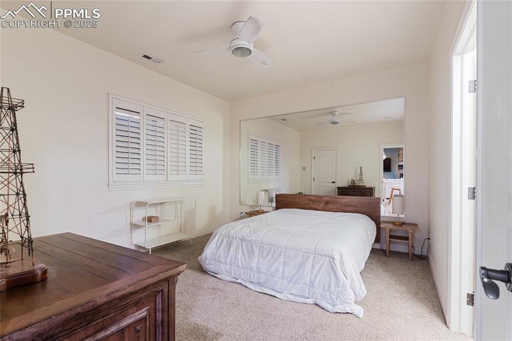 Image 41 of 46: Carpeted bedroom featuring ceiling fan