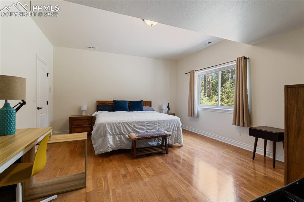 Image 43 of 46: Bedroom featuring wood finished floors and baseboards
