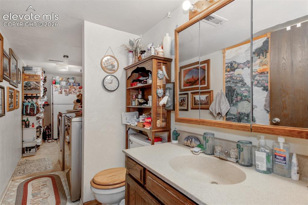 Image 12 of 45: Half Bath, Laundry area. and more storage off of Family Room.
