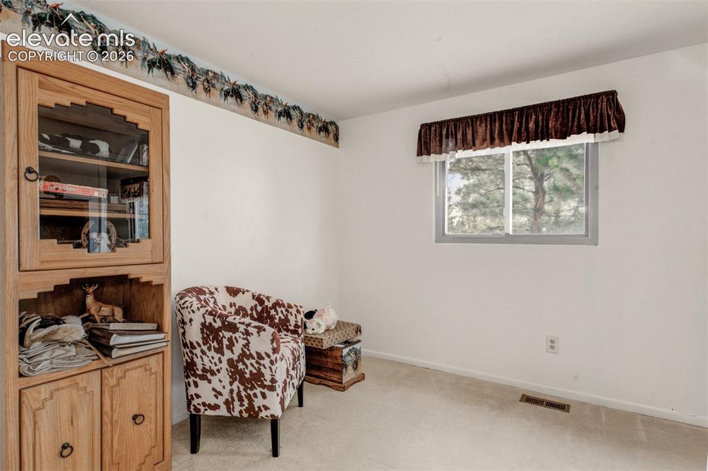 Image 23 of 45: Bedroom three with wall-mounted valance over window, and wall-to-wall carp
