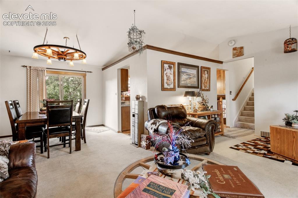 Image 8 of 45: Vaulted ceiling over carpeted flooring