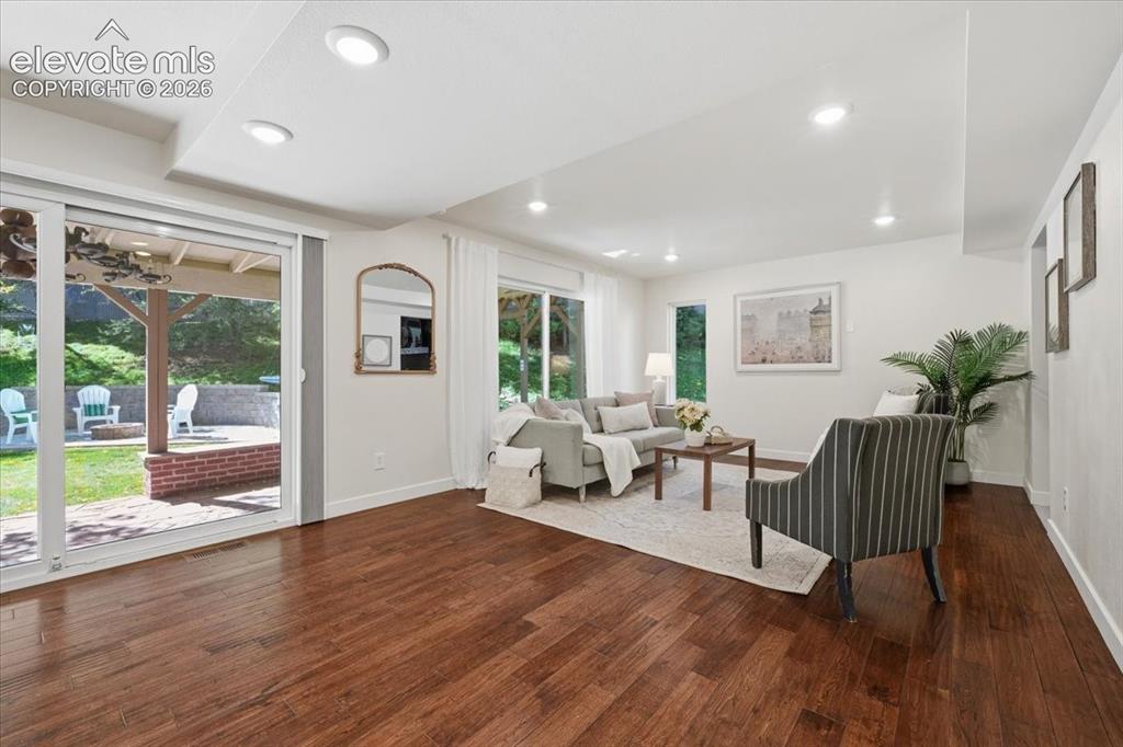 Image 13 of 50: Wood flooring throughout, recessed lighting, and extra wide sliding glass d
