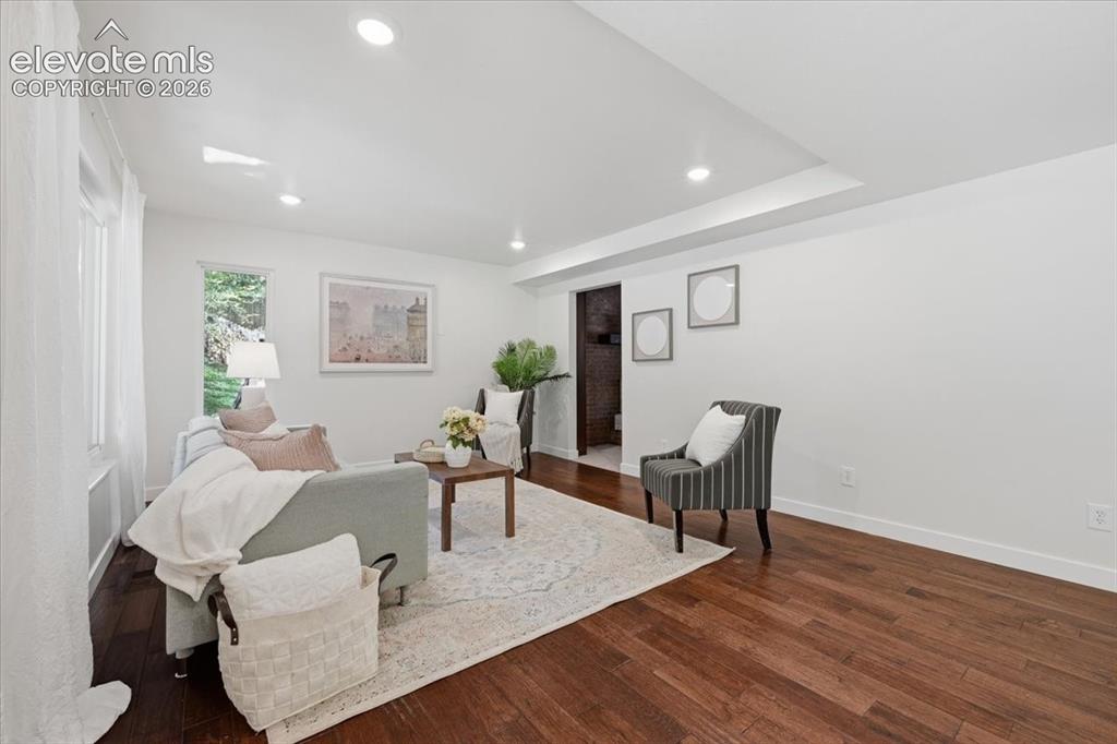 Image 14 of 50: Recessed lighting, dark wood flooring, and white walls. Bright Modern Feel