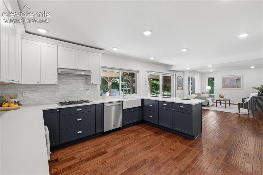 Image 16 of 50: Open concept kitchen featuring two- one cabinetry, a gas range, stainless s
