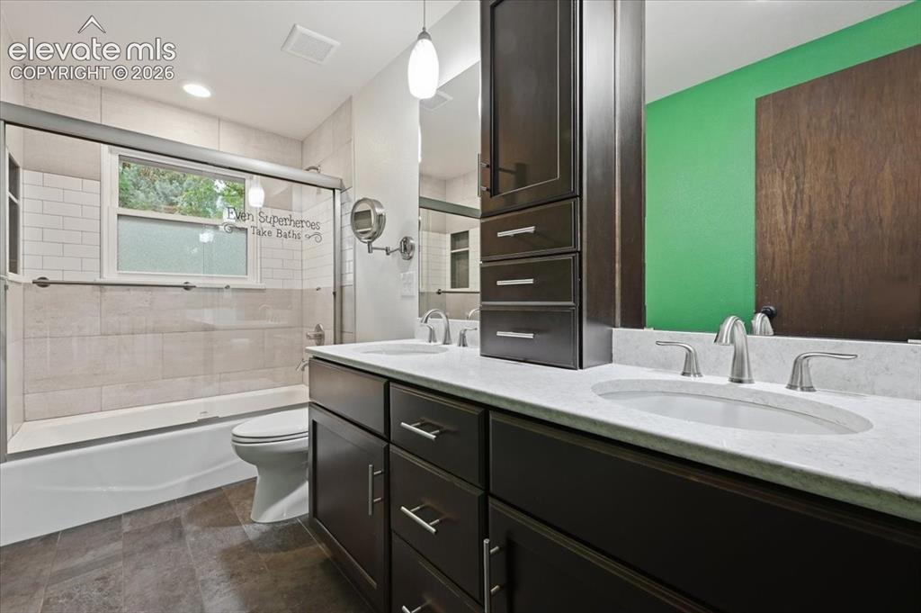 Image 31 of 50: Dual vanity with under-mount sinks and brushed nickel faucets, dark wood-fi
