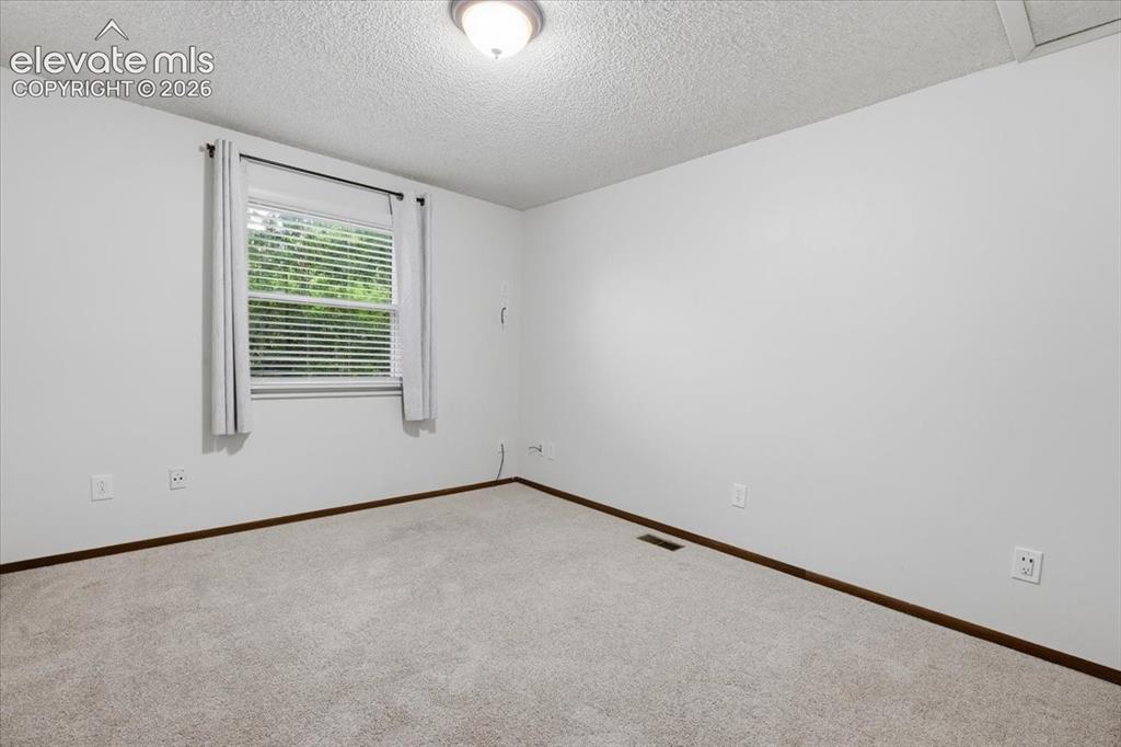 Image 32 of 50: Bedroom 3 - Neutral wall finishes, and overhead lighting