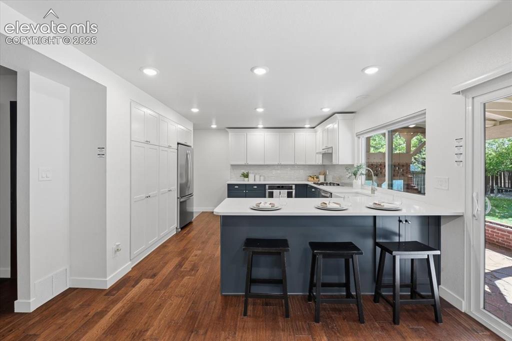 Image 4 of 50: Remodeled Kitchen featuring Dual Color Cabinets, recessed lighting,  with a