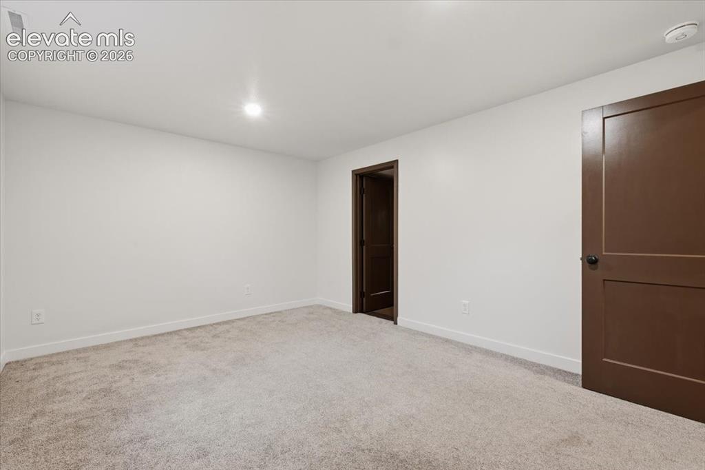 Image 43 of 50: Bedroom 5 - Basement - Neutral tone wall finishes, recessed ceiling lightin