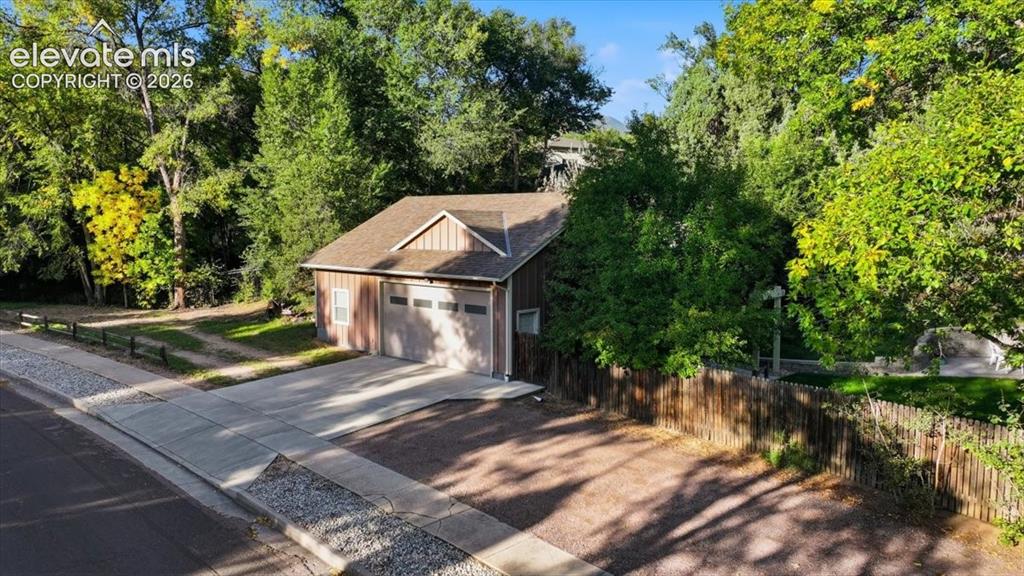 Image 44 of 50: Detached garage structure featuring a two-car garage door, Secure RV parkin