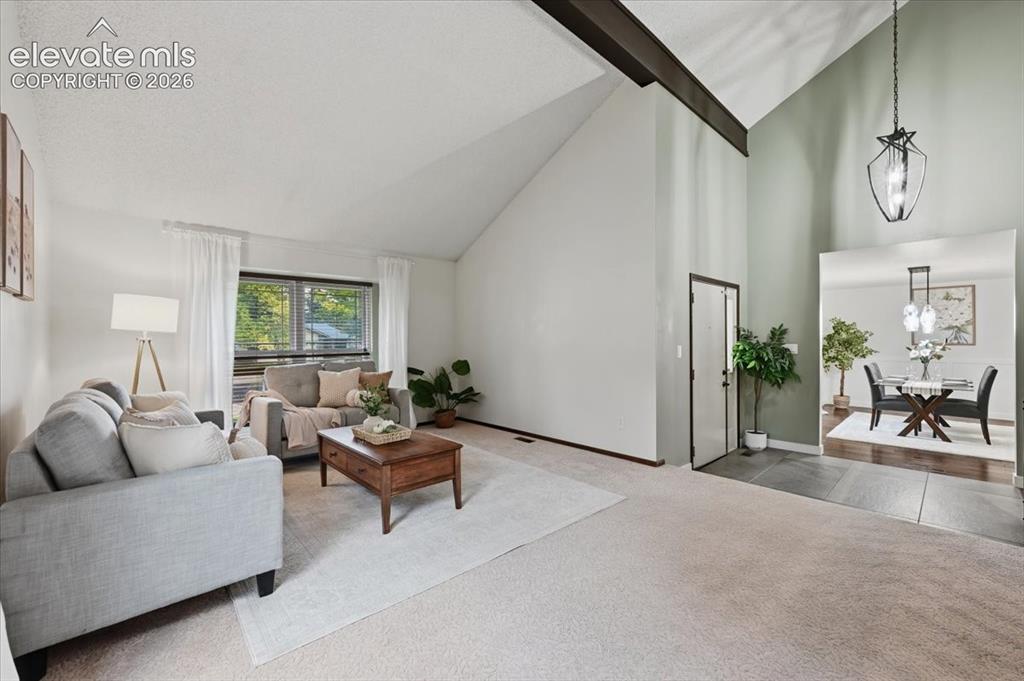 Image 5 of 50: Vaulted ceiling with exposed beam, large windows