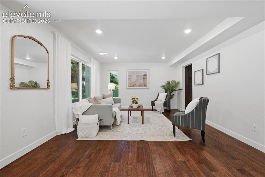 Image 6 of 50: Recessed ceiling lighting, wood flooring, and a sliding glass door