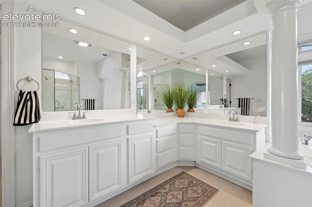 Image 21 of 45: Expansive vanity area featuring dual integrated sinks with chrome faucets