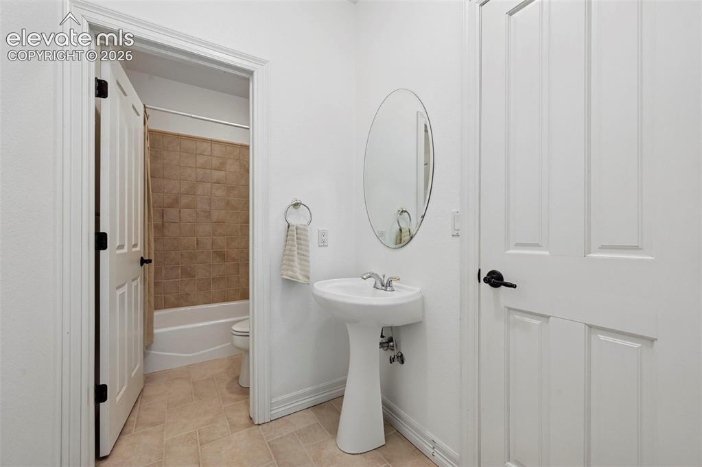 Image 29 of 45: Pedestal sink with oval mirror and polished chrome faucet