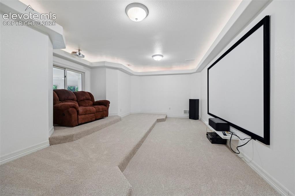 Image 31 of 45: Dedicated media room with tiered seating platforms