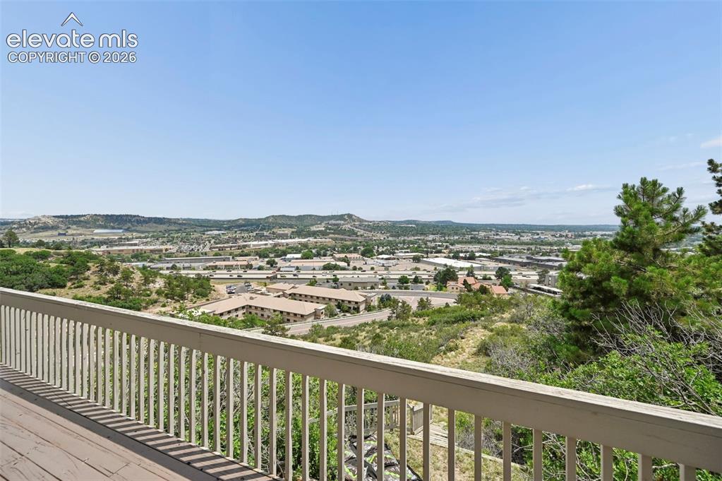 Image 43 of 45: Expansive outdoor deck with white railing, offering elevated regional scene