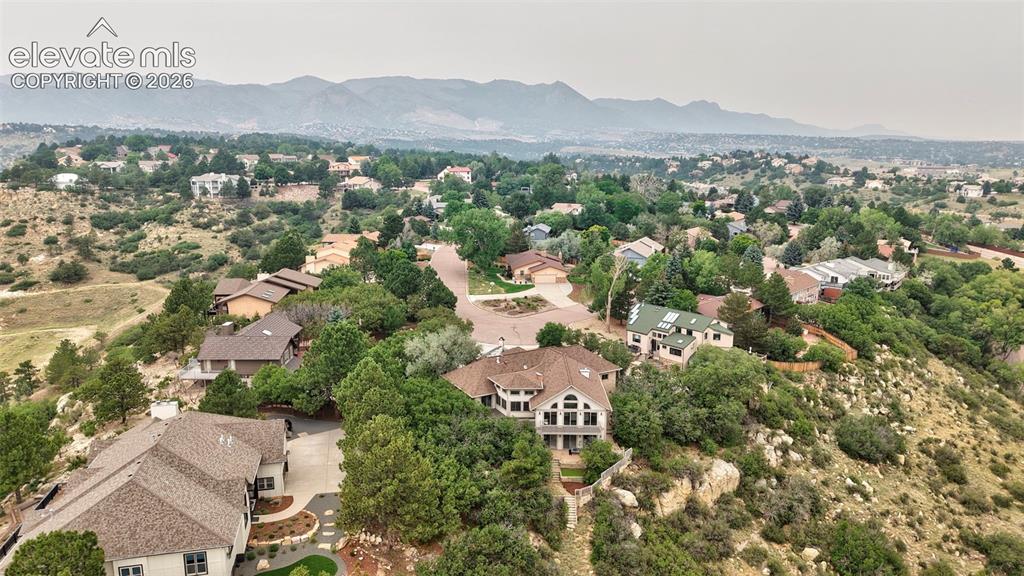 Image 5 of 45: Elevated property showcasing extensive landscaping, a curved driveway, and 