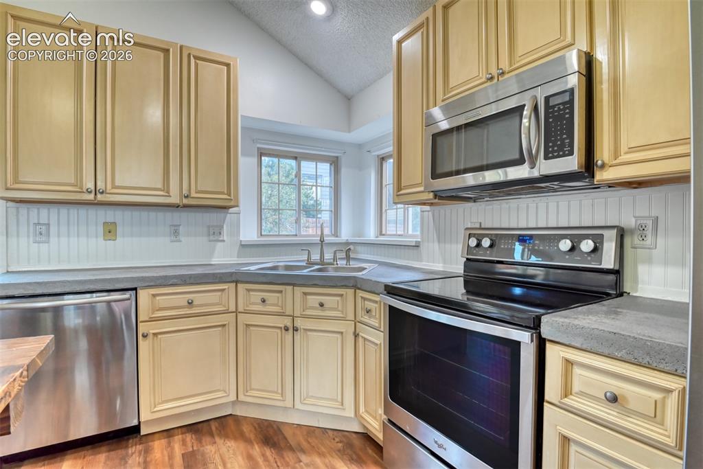 Image 17 of 48: Kitchen featuring light-toned cabinetry, stainless steel appliances, a corn