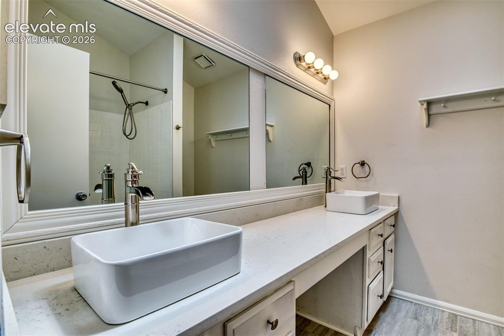 Image 22 of 48: Dual vessel sinks with brushed nickel fixtures