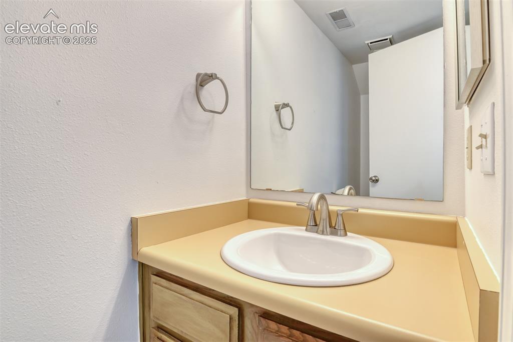 Image 40 of 48: Single vanity with an integrated sink, brushed nickel faucet, and a large w