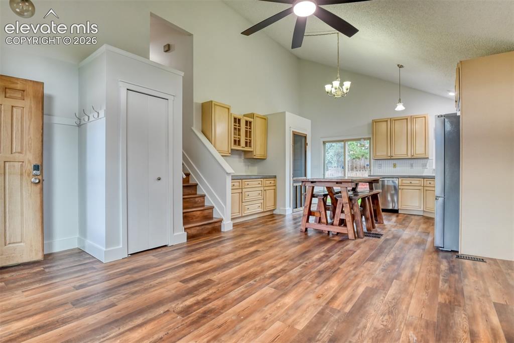 Image 7 of 48: Vaulted ceiling with a ceiling fan, recessed lighting, wood-finish flooring