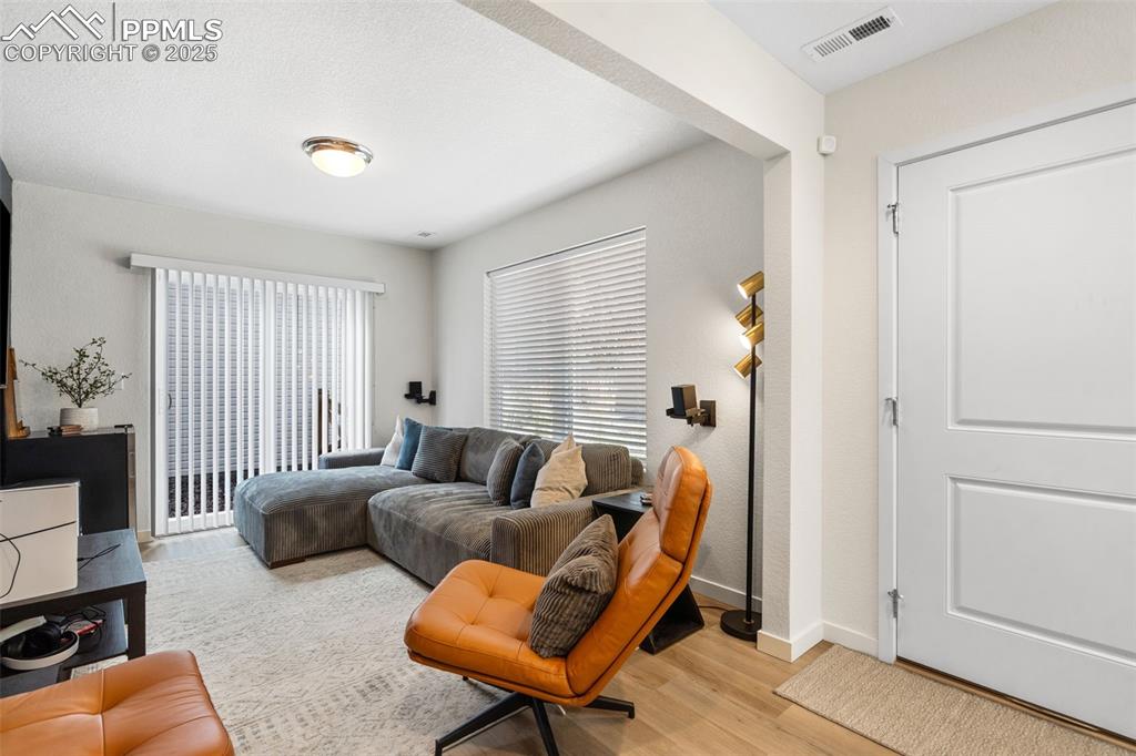 Image 10 of 15: 1st floor entry with attached flex-room and slider door to side yard