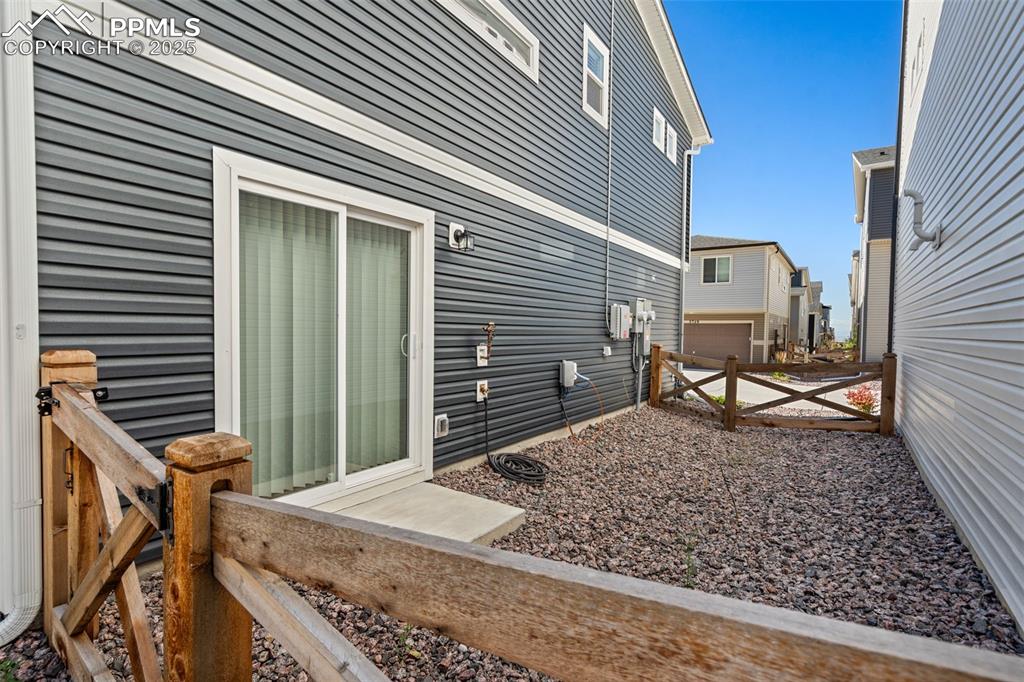 Image 15 of 15: Fenced yard off 1st floor flex-room slider door