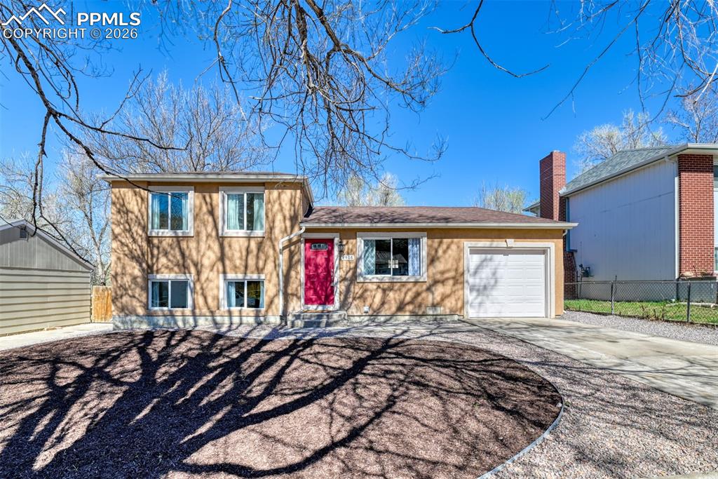 Image 1 of 39: The property features a two-story design with a warm exterior, a vibrant re