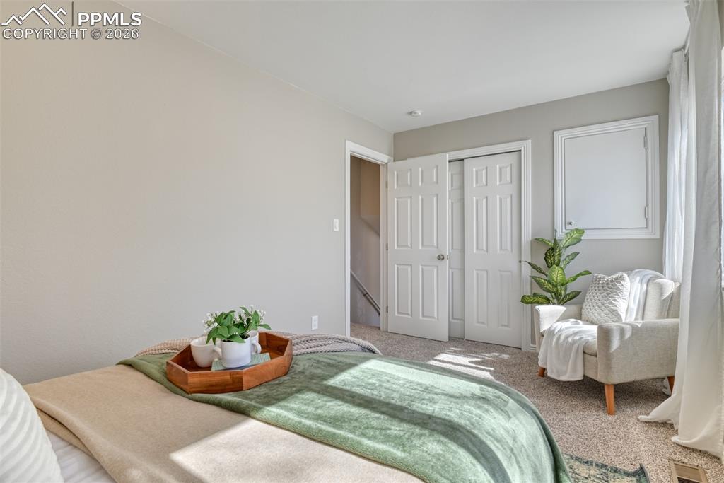 Image 17 of 39: This room features light-colored walls and soft carpet flooring