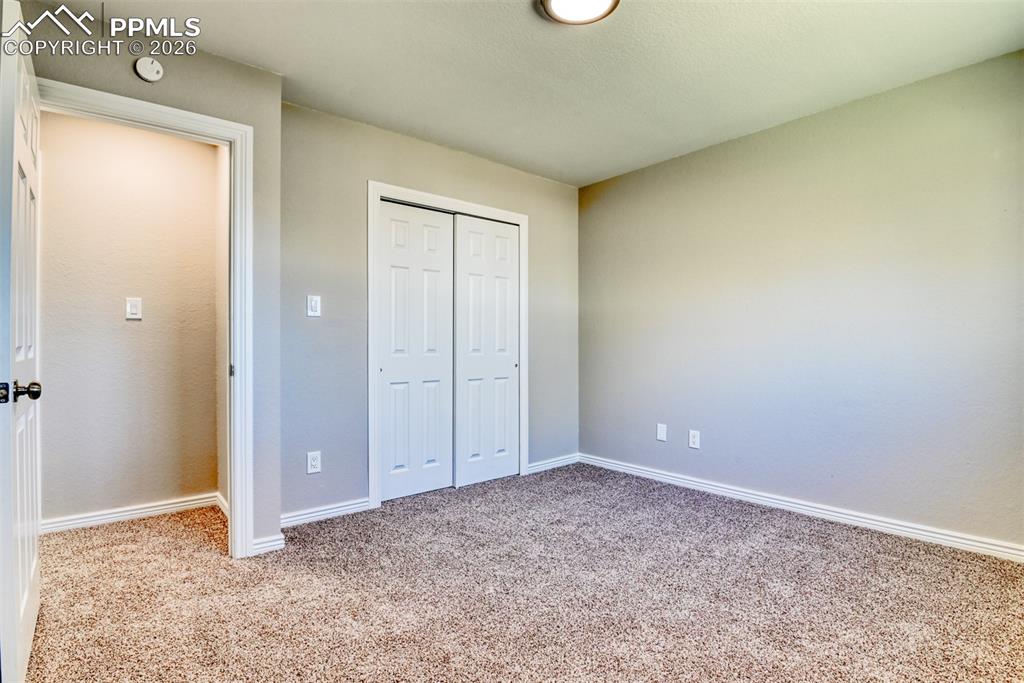 Image 23 of 39: This room features light brown carpeting, neutral wall colors, and a ceilin