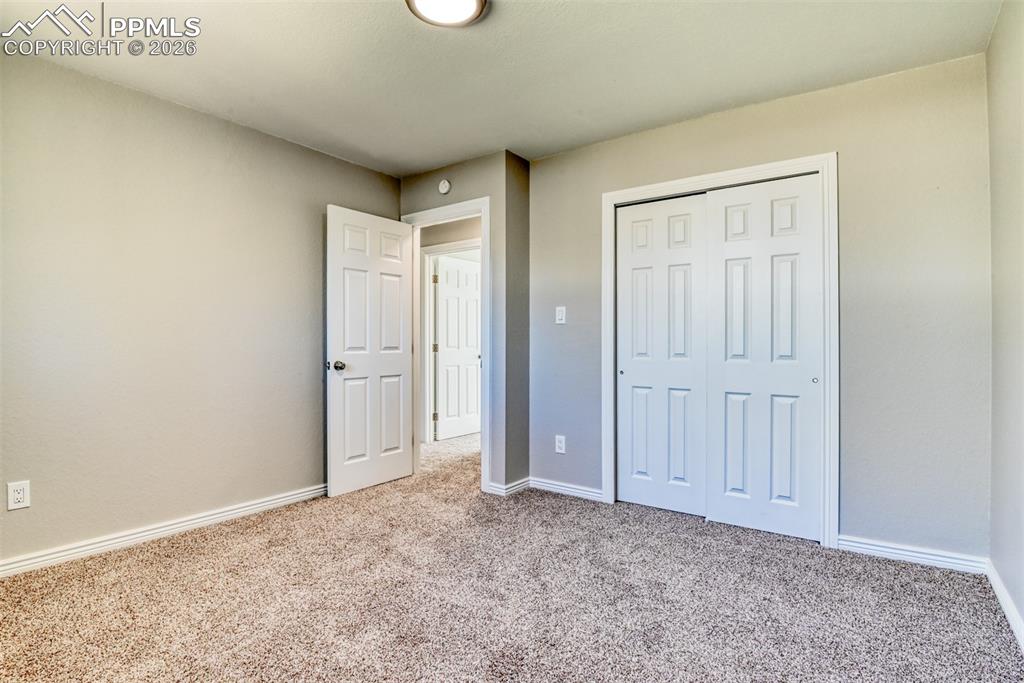 Image 24 of 39: This room features carpeting, a neutral color palette, white trim, and a wh