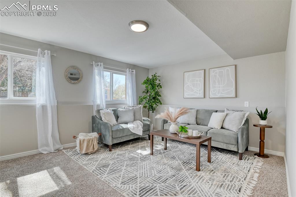 Image 26 of 39: Inviting living area featuring light gray walls, two windows, and recessed