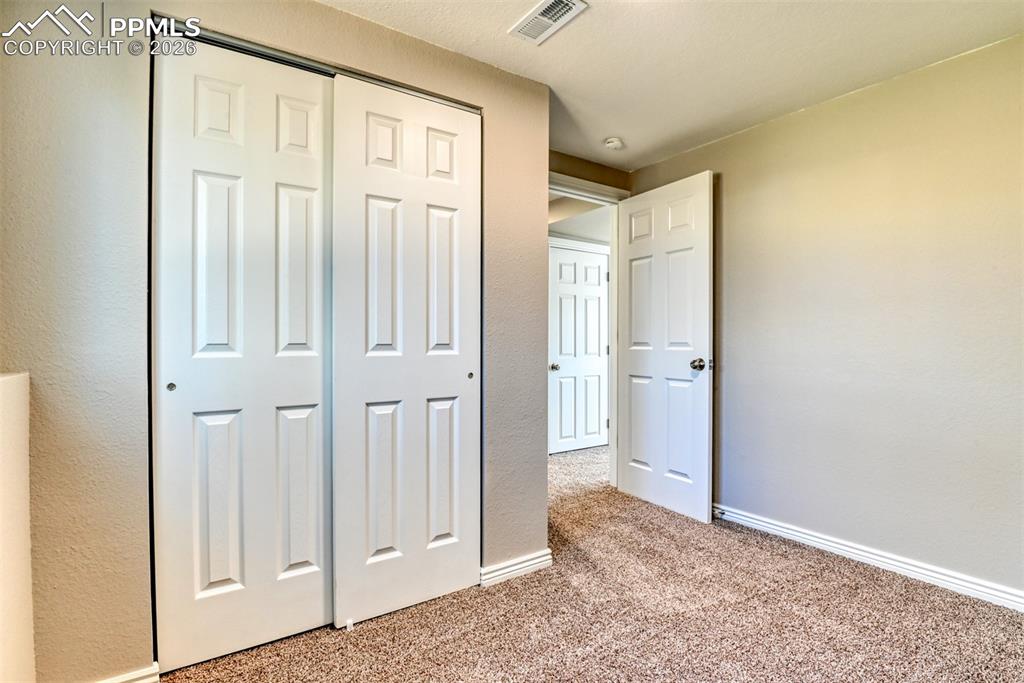 Image 34 of 39: The room features warm neutral-toned walls, contrasting white trim, and a t
